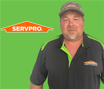 Man in front of SERVPRO green and logo
